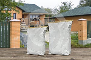 Paper bags on boards. Plaster cement sacks on blurred background of house construction