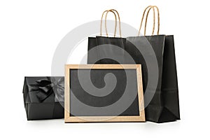 Paper bags, chalkboard and gift box isolated on white background