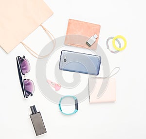 Paper bags and many purchases of gadgets and accessories on a white background: sunglasses, smartphone, smart bracelet, powel bank