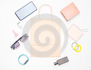 Paper bags and many purchases of gadgets and accessories on a white background: sunglasses, smartphone, smart bracelet, powel bank