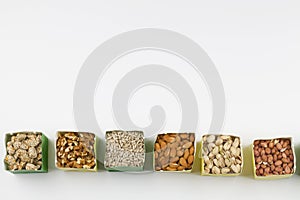 Paper bags with pistachios sunflower seeds walnuts cashew peanut almond pine nuts