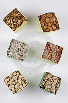 Paper bags with pistachios sunflower seeds walnuts cashew peanut almond pine nuts