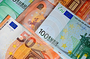 Paper banknotes of Euro 50 and 100. Cash closeup, color background of money view from above