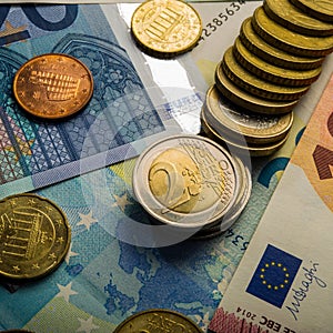 Paper banknotes of ten euros and coins.