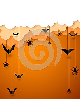 Paper bats and spiders on orange background