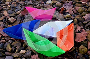 Paper boat floats on the water, origami photo