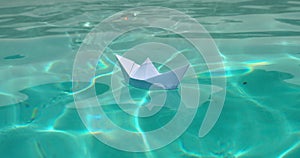 Paper boat floats on the water. Happy child dream concept. Dreams, future, childhood, freedom or hope concept. Small