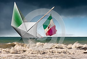 Paper boat with Italian flag is sinking into the sea - Fragility concept