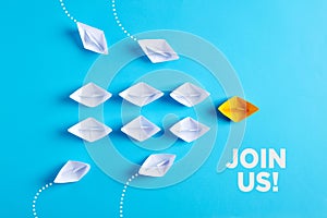 Paper boat leads white paper ships with new ones joining the team. Join us, job vacancy or community membership