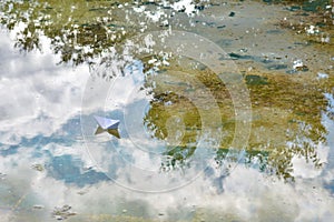 White paper boat on water photo