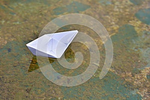 White paper boat on water photo