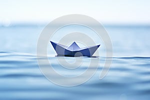 Paper boat on sea wave