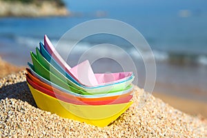 Paper boats at the beach