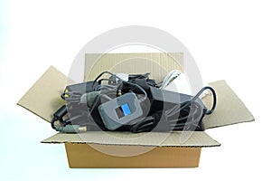 Paper box with the damaged or old used Adapter power charger of laptop computer or electrical appliances on white