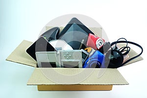 Paper box with the damaged or old used electronics gadgets for daily use on white background