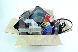 Paper box with the damaged or old used electronics gadgets for daily use on white background photo