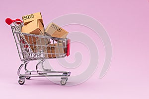 Paper boxes in shopping cart on Violet background with copy space. For online shopping business, promotion and marketing concept