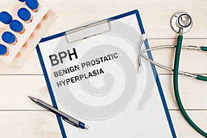 Paper with BPH - Benign Prostatic Hyperplasia on a table, stethoscope and pen