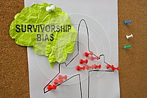 Paper brain with the inscription survivorship bias pinned to the board.