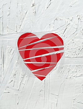 Paper broken heart on white wooden background