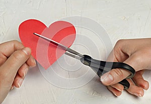 Paper broken heart on white wooden background