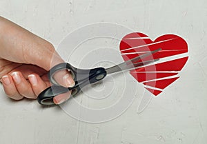 Paper broken heart on white wooden background