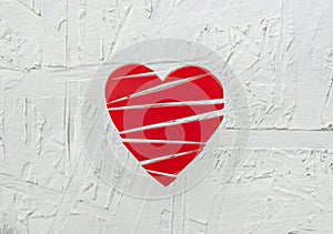 Paper broken heart on white wooden background