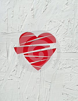 Paper broken heart on white wooden background