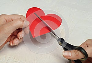 Paper broken heart on white wooden background