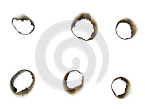 Paper burns on white backgrounds. close up hole paper with edges burned on white background.