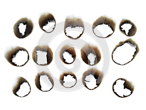 Paper burns on white backgrounds. close up hole paper with edges burned on white background.