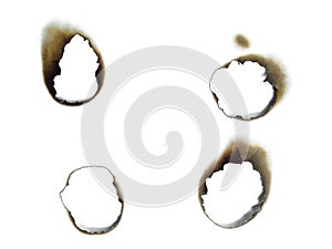 Paper burns on white backgrounds. close up hole paper with edges burned on white background.