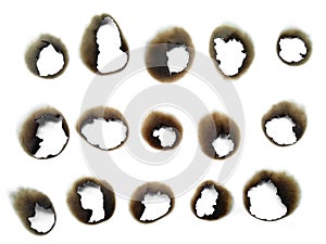 Paper burns on white backgrounds. close up hole paper with edges burned on white background.