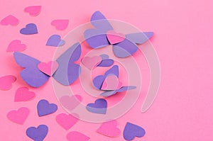 Paper butterflies and hearts on a pink background,Valentine`s Day