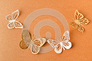 The Paper butterflies on a orange paper background with empty space