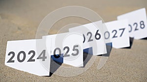 Paper cards with numbers of years from 2024 to 2028 in a row. New year start concept. Resolution time is flying plan