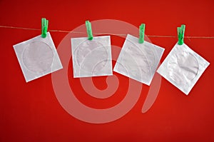 Paper CD envelopes hanging isolated on a red background