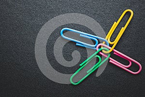 Paper clips on black background