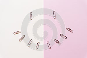 Paper clips isolated on white background and pink background