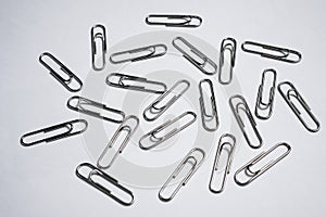 Paper clips like footprints on white background.