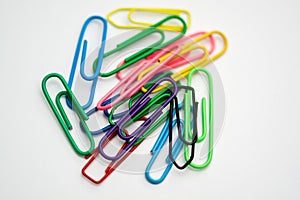 Paper clips of various colors on a white folio