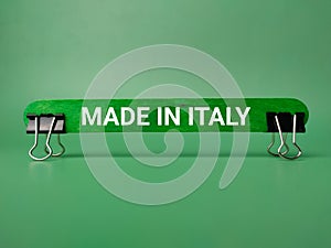 Paper clips and wooden stick with the word MADE IN ITALY