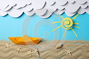 Paper clouds, sun and boat, sand with starfishes on background. Vacation