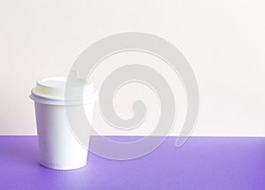 Paper Coffee glass with on a lilac background. Takeaway,