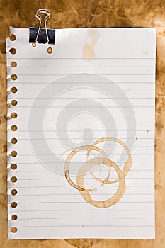 Paper with coffee stains and clip