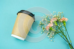 paper coffee to go cup and flwers on blue background