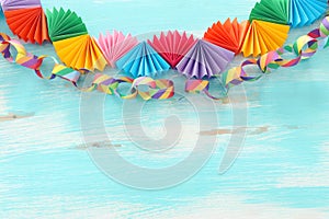 Paper colorful chain garland over white wooden background. Traditional jewish sukkot holiday decoration