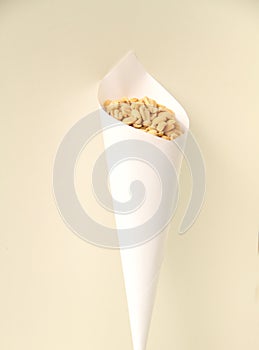 Paper cone with salted peanut isolated white background Sao Paulo Brazil