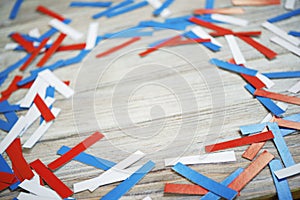 Paper confetti of national colors of France, Russia, USA, Serbia white-blue-red on a white wooden background, the concept of indep