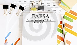 Paper with Corrective and Preventive FAFSA action plans on a table with charts photo